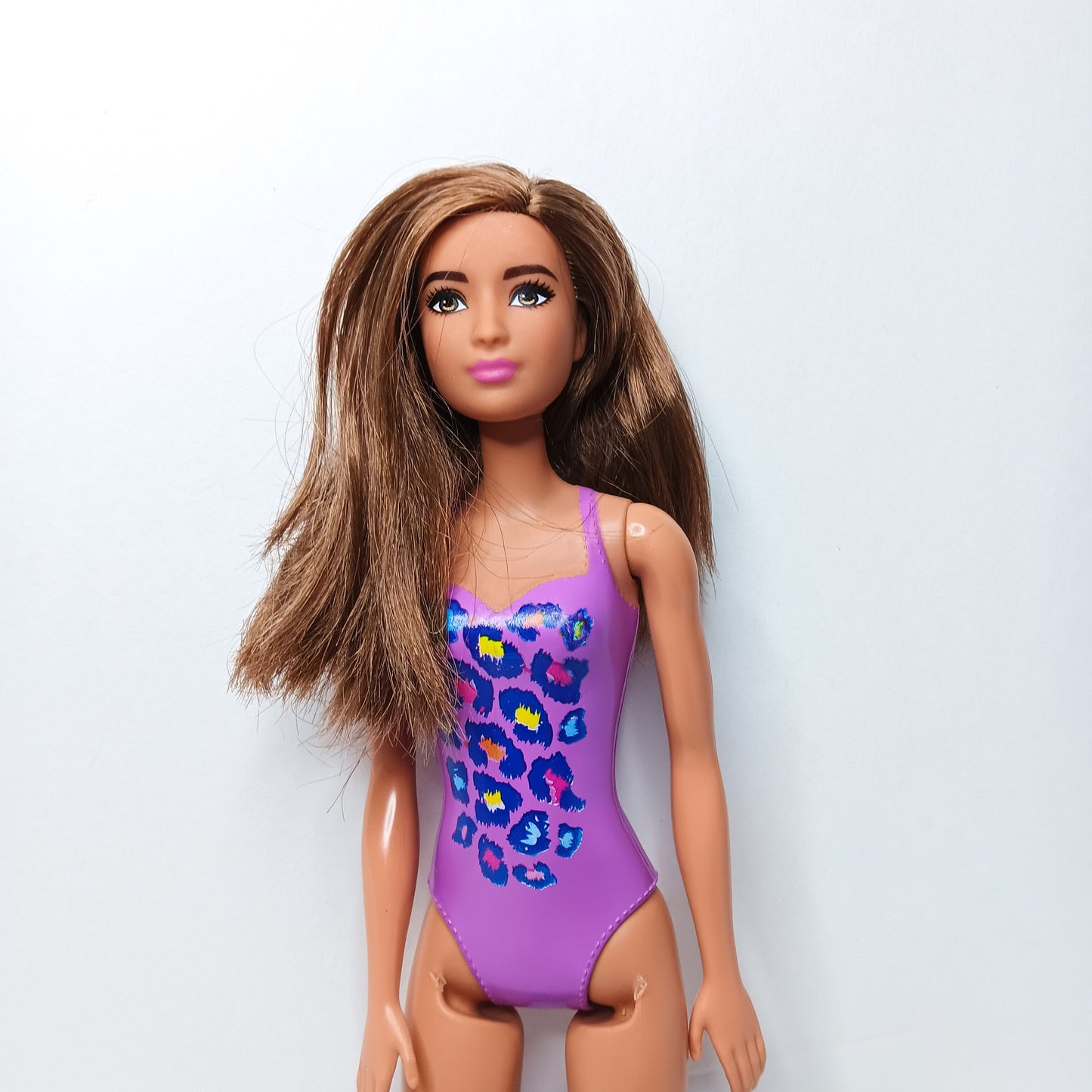 BARBIE DOLL- LONG BROWN HAIR WEARING PURPLE MOLDED-ON SWIMSUIT